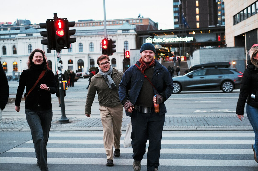 People crossing a busy downtown street in a Canadian city