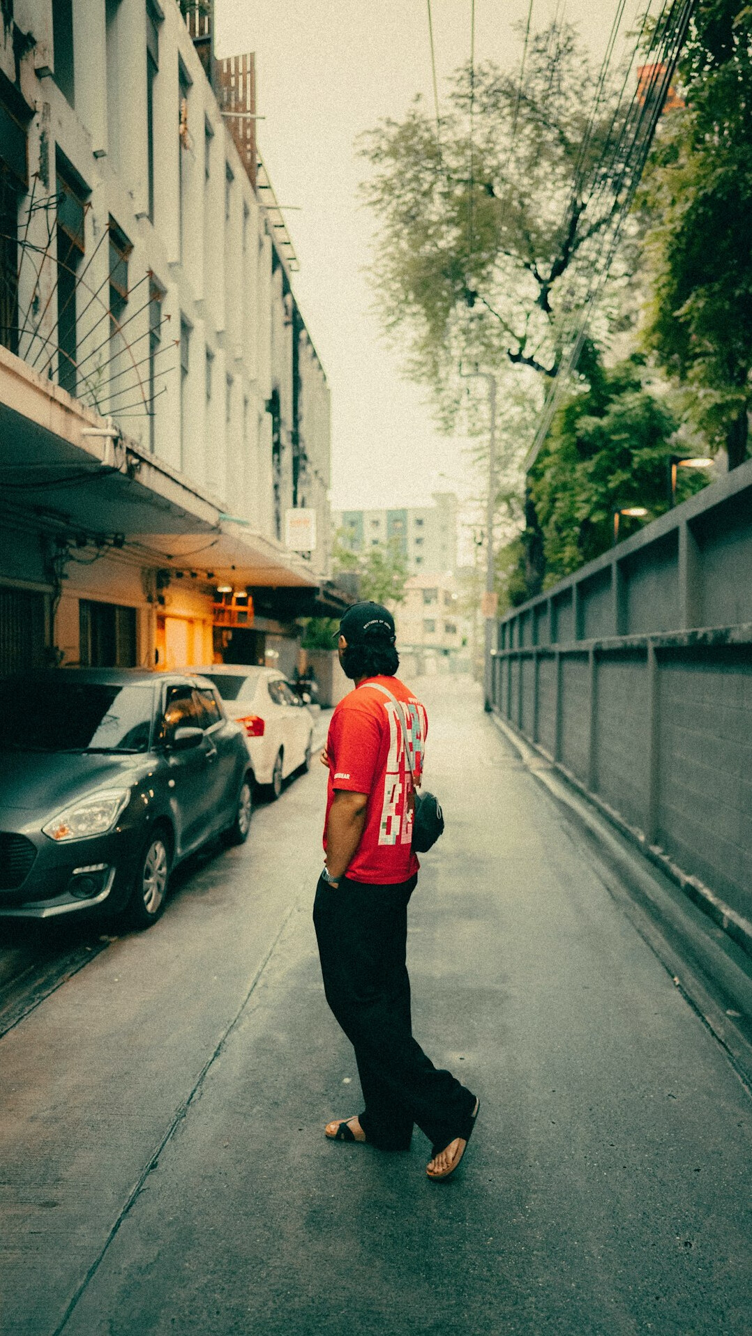 Documentary photographer walking a city street holding a camera