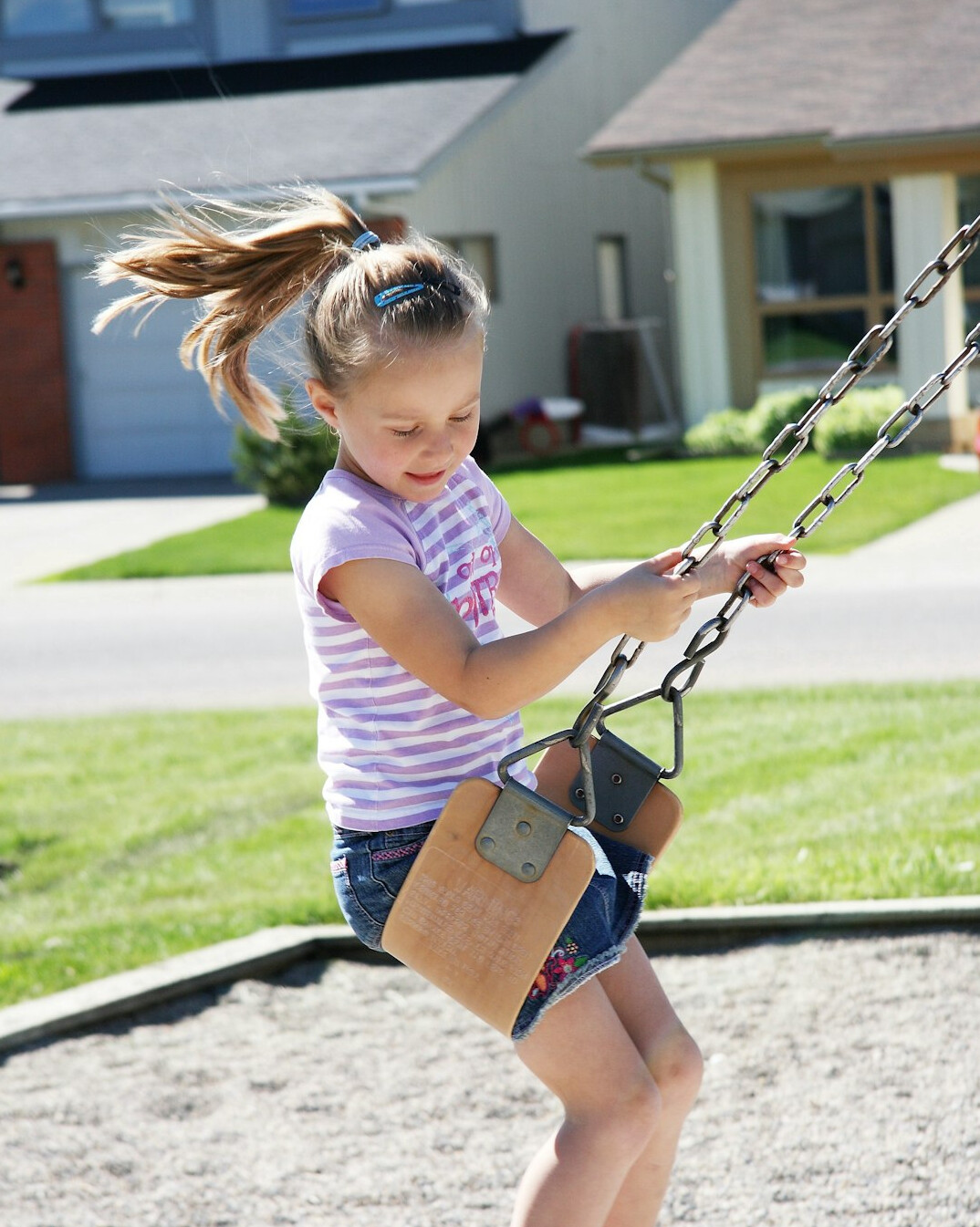 Young child playing outside in a neighborhood park